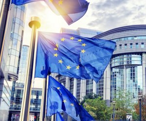 EU flags waving in front of European Parliament building in Brus