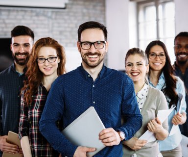 Portrait of successful young business team posing in office