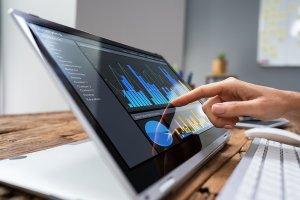 Businesswoman Analyzing Graph On Laptop