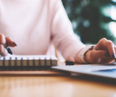 Selective focus on hipster girl writing interesting ideas for sc