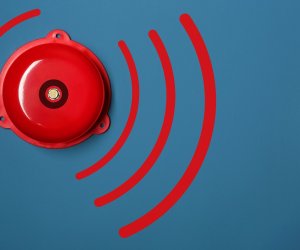 Modern alarm bell on color background