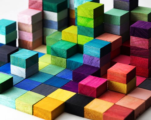 Spectrum of stacked multi-colored wooden blocks. Background or c