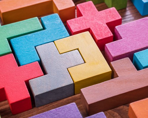 The concept of logical thinking. Geometric shapes on a wooden background.